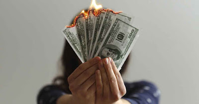Common Money Mistakes Women in Their 20s Make Visual of a common financial mistake: wasting money and literally 'burning cash.' A warning against poor spending habits.