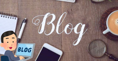 A desk with a laptop, notebook, and phone, with the word "Blog" written on it